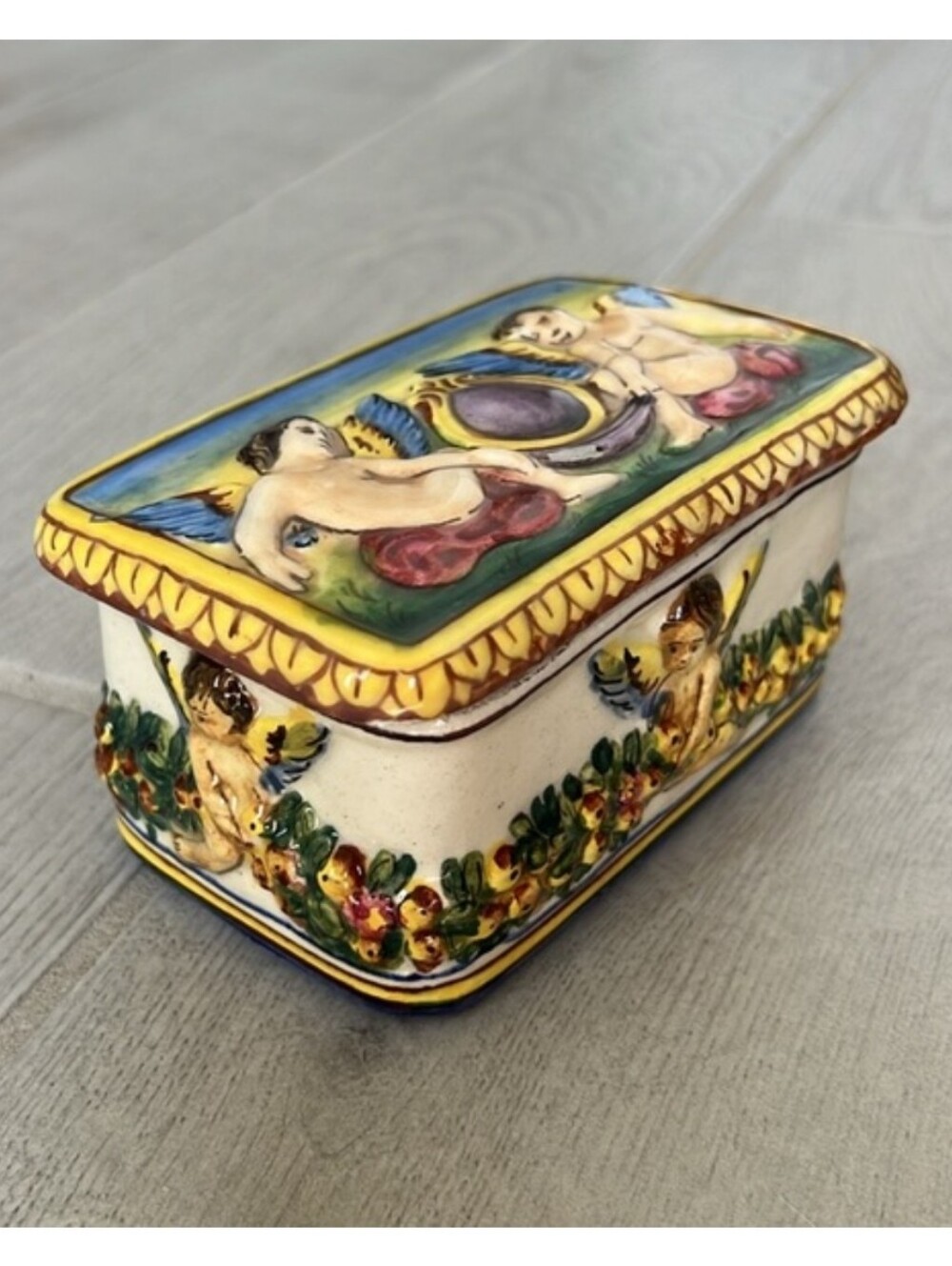 vintage Italian porcelain trinket box featuring hand-painted relief cherubs